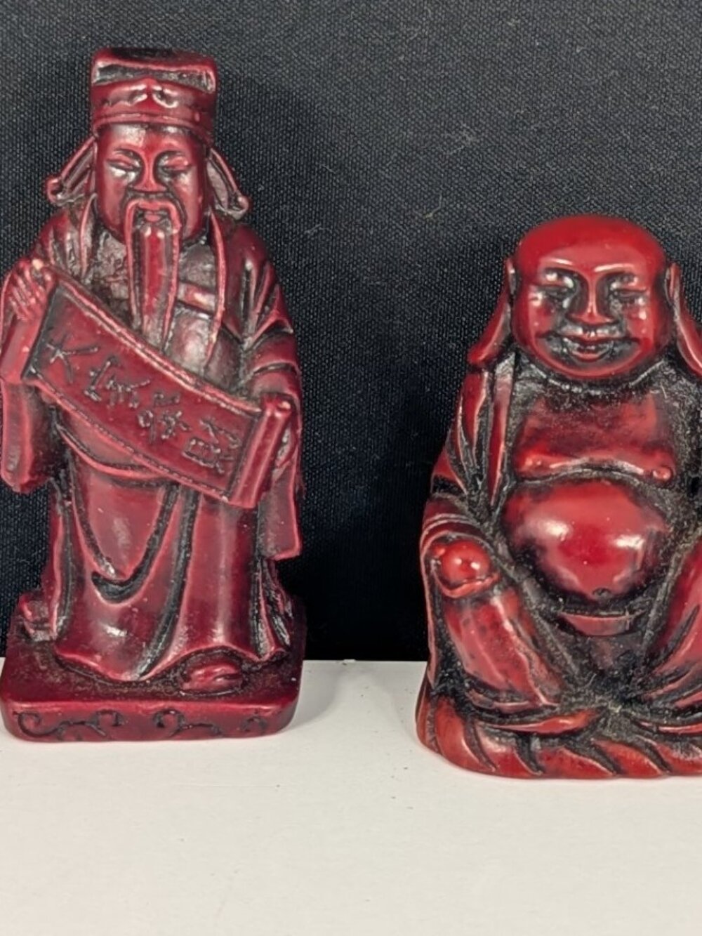 Two red resin Chinese deity statues for good luck